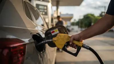 Tanque de combustível de carro sendo abastecido em posto com etiqueta de identificação de gasolina comum e aditivada.