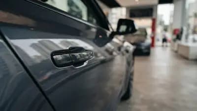 Detalhe da maçaneta de uma porta de carro elétrico Tesla com reflexo urbano em uma concessionária moderna